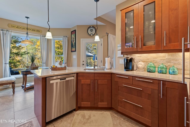 kitchen with stainless steel dishwasher, sink, decorative light fixtures, and tasteful backsplash