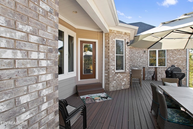 wooden terrace featuring area for grilling