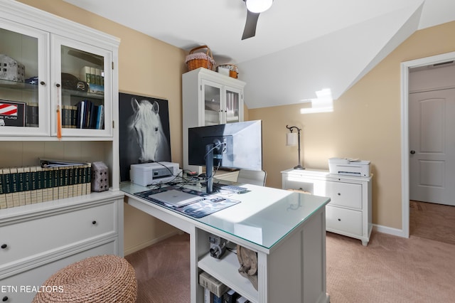 home office featuring lofted ceiling, light colored carpet, and ceiling fan