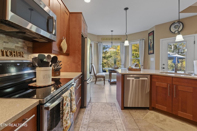339 Eagles Rdg, Tazewell, TN 37879 - kitchen with stainless steel appliances, light countertops, a sink, backsplash, and brown cabinetry