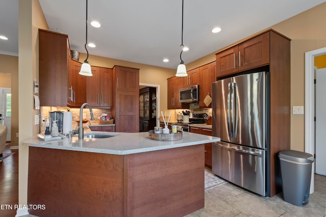 kitchen featuring decorative backsplash, stainless steel appliances, sink, and pendant lighting