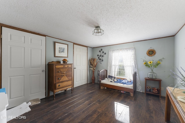 sitting room featuring a textured ceiling, dark hardwood / wood-style flooring, and ornamental molding