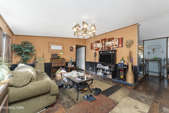 living room featuring a chandelier, dark hardwood / wood-style floors, and ornamental molding