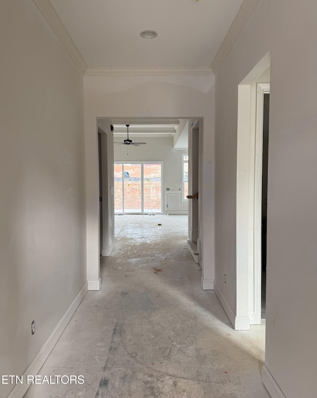 corridor featuring baseboards and ornamental molding