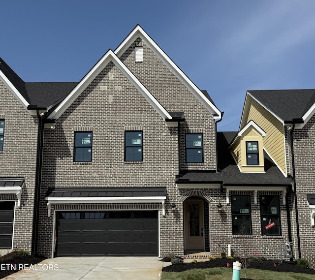 view of front of house with brick siding, concrete driveway, and an attached garage