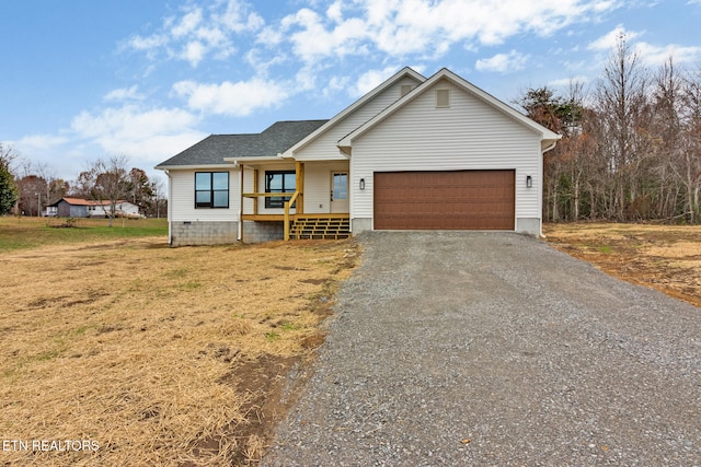 view of front of house featuring a front yard, a porch, and a garage