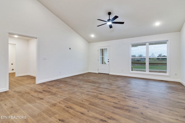 unfurnished living room with ceiling fan, high vaulted ceiling, and wood-type flooring