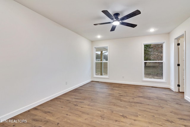 empty room with light wood-type flooring, plenty of natural light, and ceiling fan