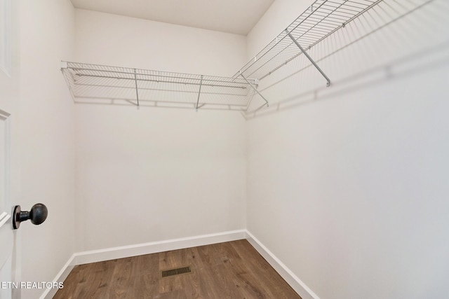 walk in closet featuring hardwood / wood-style flooring