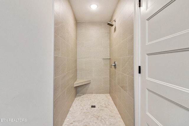 bathroom with a tile shower