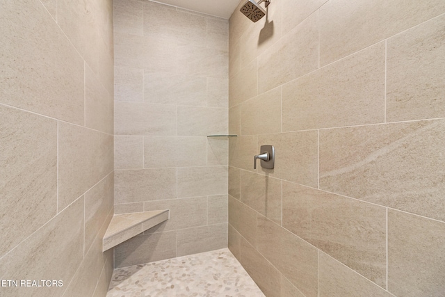 bathroom with tiled shower