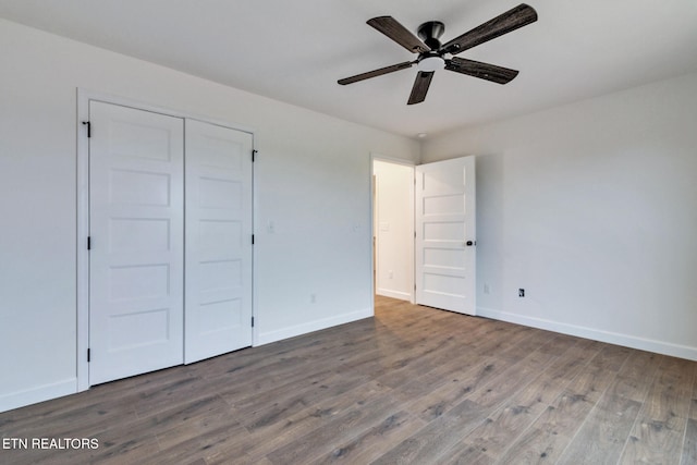 unfurnished bedroom featuring hardwood / wood-style floors, ceiling fan, and a closet