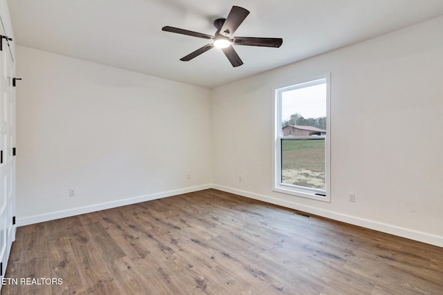 empty room with ceiling fan and wood-type flooring