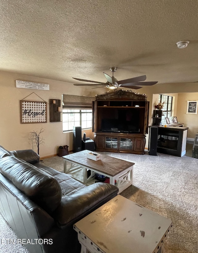 living room featuring carpet, a textured ceiling, and ceiling fan