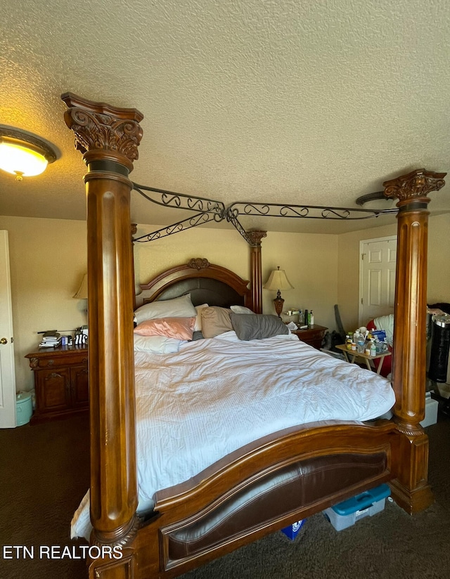 carpeted bedroom featuring a textured ceiling