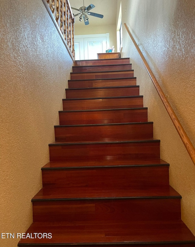 staircase with ceiling fan