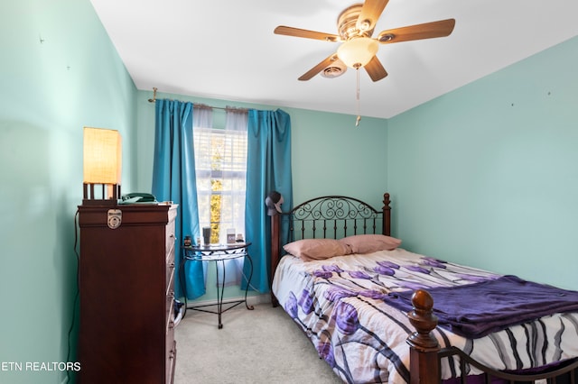 bedroom with baseboards, a ceiling fan, and light colored carpet