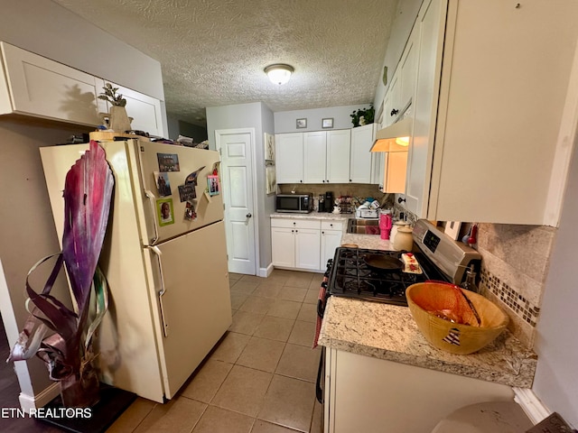 kitchen featuring white cabinets, sink, decorative backsplash, and appliances with stainless steel finishes