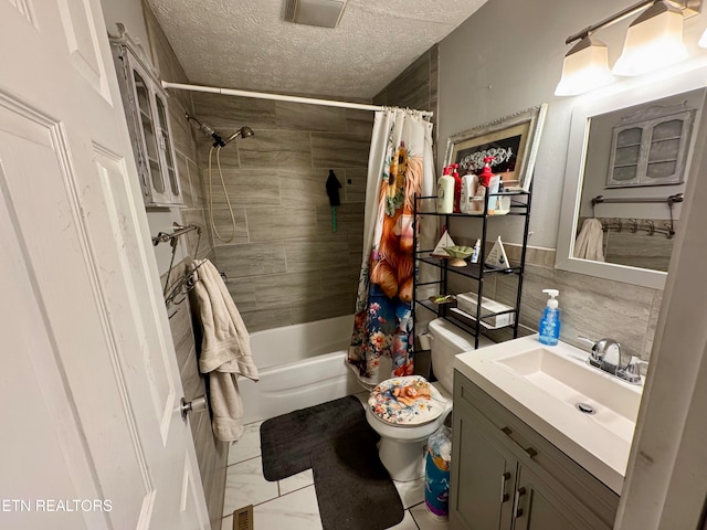 full bathroom featuring vanity, shower / bath combo, a textured ceiling, and toilet