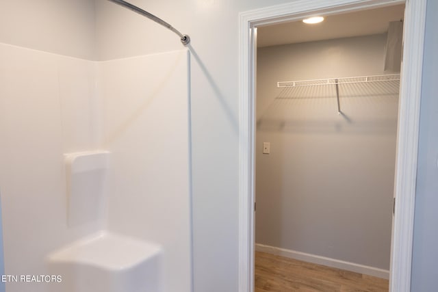 bathroom featuring a shower and hardwood / wood-style flooring