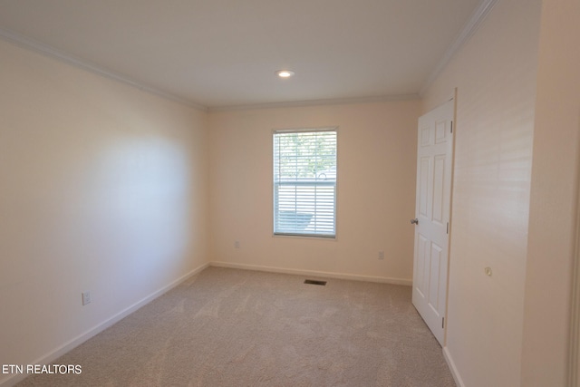 carpeted spare room featuring ornamental molding