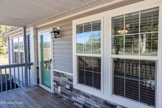 view of exterior entry with a deck