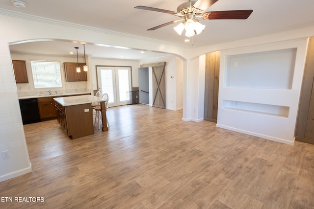 kitchen featuring light hardwood / wood-style floors, dishwasher, a center island, and hanging light fixtures