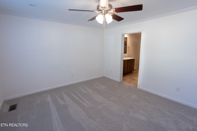 carpeted spare room with crown molding and ceiling fan