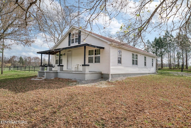 view of front of home featuring covered porch and a front yard