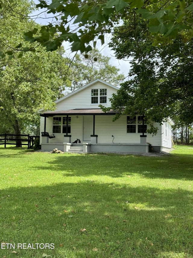 view of front of property with covered porch and a front yard