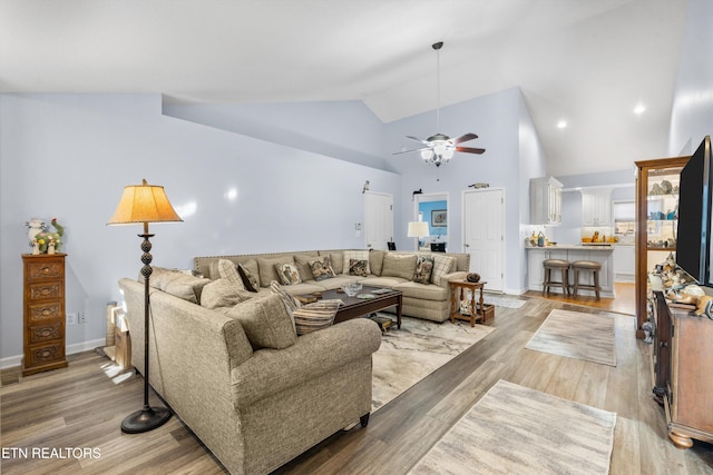 living room with high vaulted ceiling, light wood-type flooring, and ceiling fan