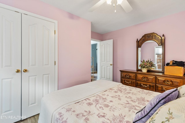 bedroom with light wood-type flooring, a closet, and ceiling fan