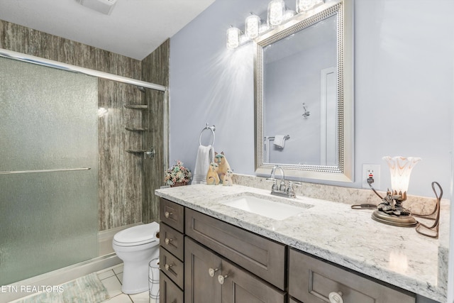 bathroom with toilet, an enclosed shower, vanity, and tile patterned flooring