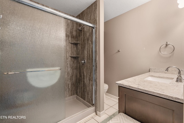 bathroom featuring vanity, tile patterned floors, toilet, and an enclosed shower