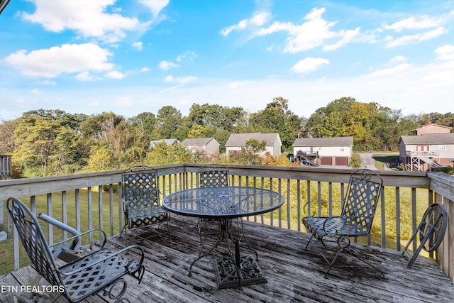 wooden deck featuring a lawn