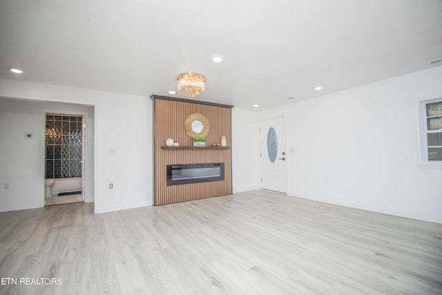 unfurnished living room with light hardwood / wood-style flooring and a fireplace