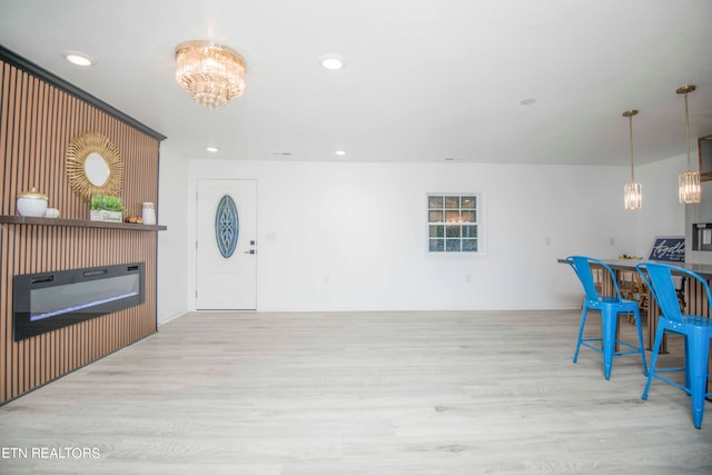 interior space featuring an inviting chandelier and light wood-type flooring