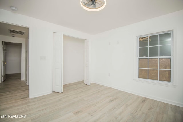 empty room featuring ceiling fan and light wood-type flooring