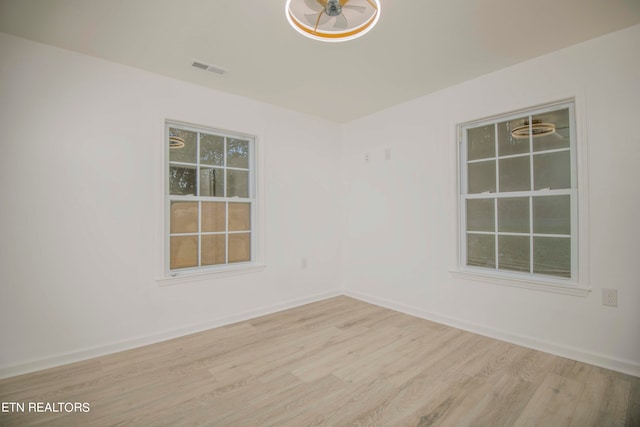 empty room with light hardwood / wood-style floors and ceiling fan