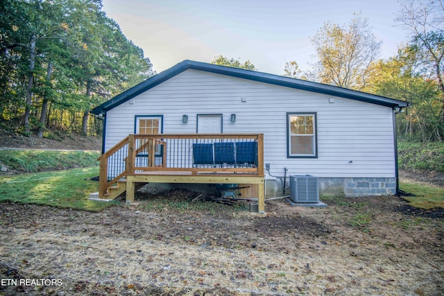 rear view of house with central air condition unit and a deck