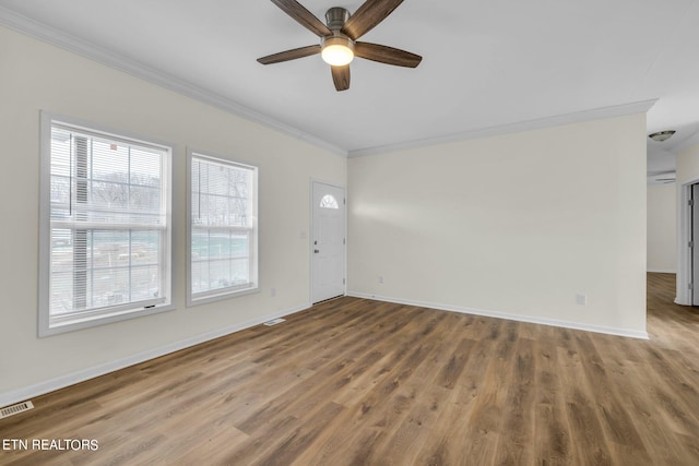 unfurnished living room with ornamental molding, hardwood / wood-style floors, and plenty of natural light