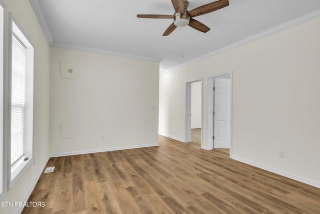 spare room featuring ornamental molding, hardwood / wood-style floors, and ceiling fan