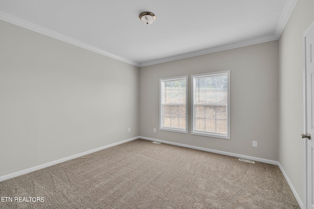 carpeted spare room featuring crown molding