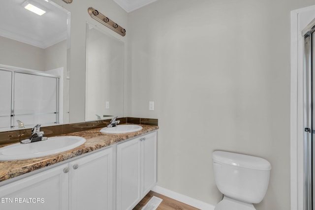 bathroom with a shower with shower door, toilet, vanity, crown molding, and hardwood / wood-style flooring