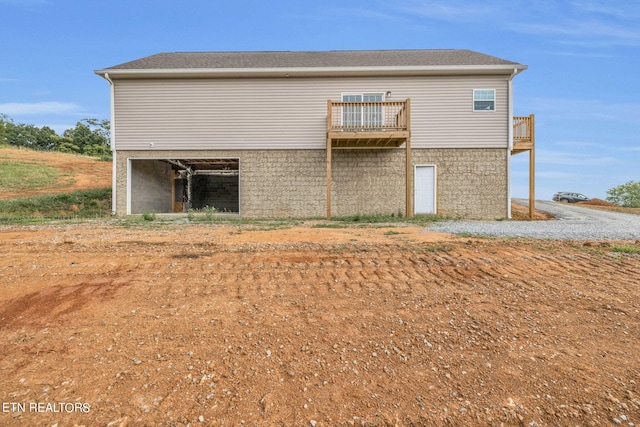 back of property featuring a balcony