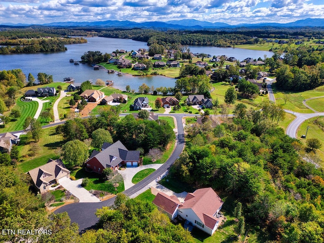 drone / aerial view with a water and mountain view