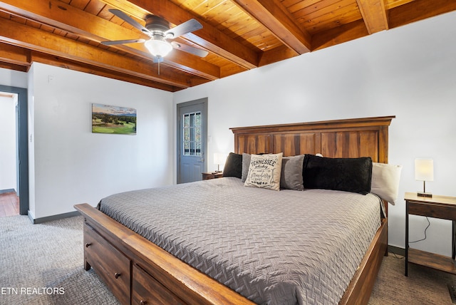 bedroom with beamed ceiling, ceiling fan, dark carpet, and wood ceiling