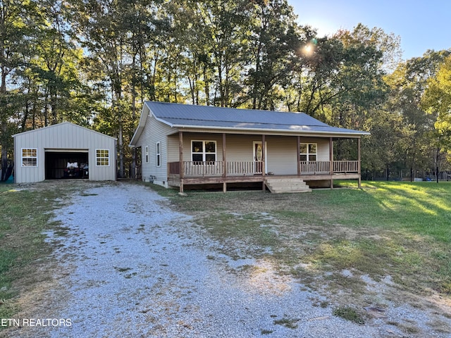 view of front facade featuring a porch, an outdoor structure, a front lawn, a deck, and a garage