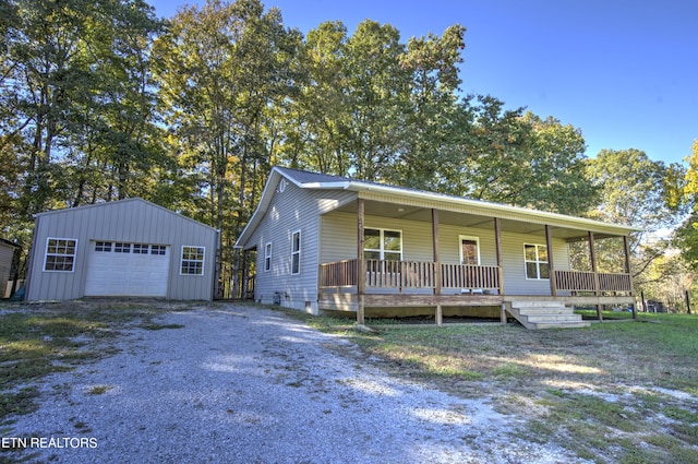 view of front of house with a porch, an outdoor structure, and a garage