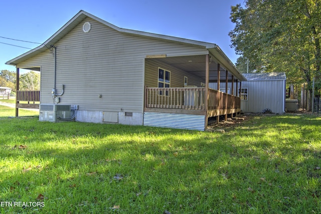 view of property exterior with cooling unit, a deck, and a yard